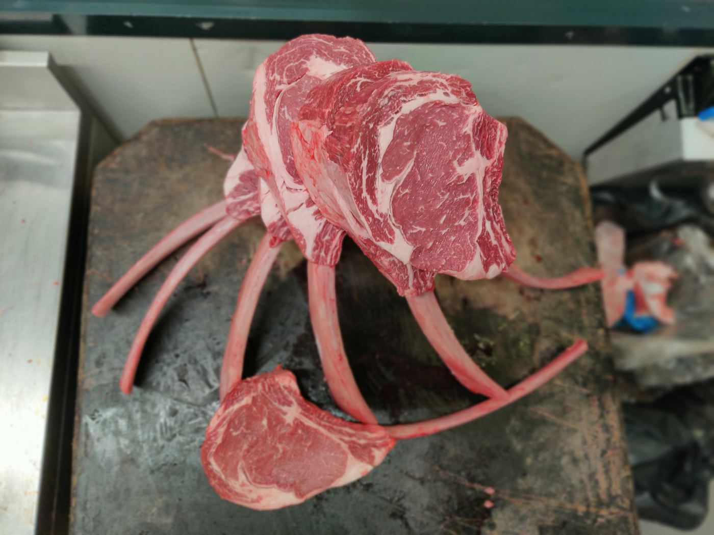 A full rack of ribs fanned out on the butcher block